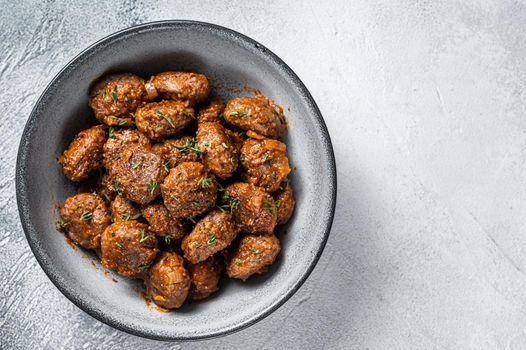 Fried Meatballs in tomato sauce from ground beef and pork meat. White background. Top view. Copy space.