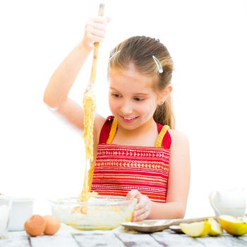 cutre little girl making dough isolated on a white background