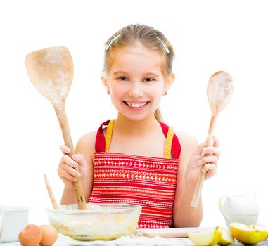 cutre little girl making dough shows wooden spoons isolated on a white background