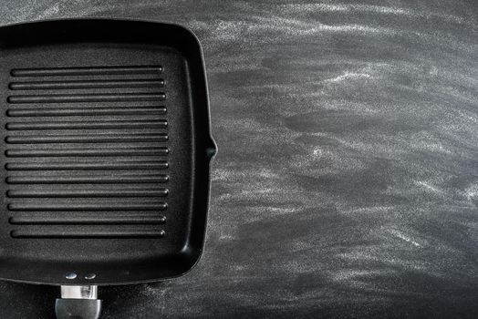Cast iron griddle pan on black background