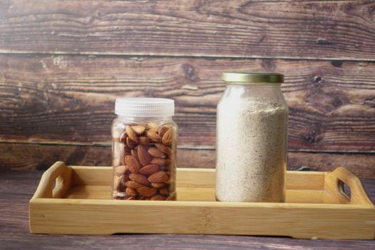 almond powder and almond in a jar on table