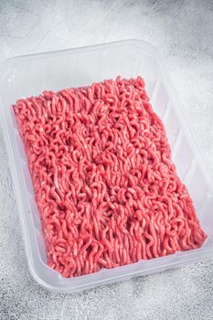 Raw ground beef and pork meat in vacuum packaging from super market. White background. Top view.