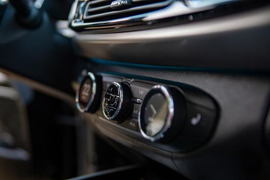 multimedia control console and climate in a modern premium car. close-up, selective focus, no people