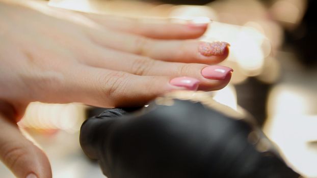 Manicure in beauty salon - fingers and nails, close up