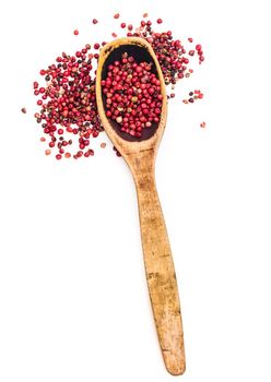 fresh pepper in wooden spoon isolated on a white background