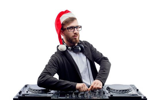 Funny Bearded man dj in christmas hat and glasses plays music on a turntable while isolated on white background. New Year party. Christmas party