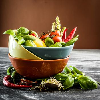 Fresh vegetables and spices in a bowl on the table