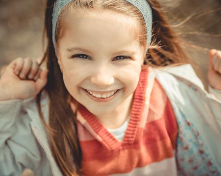 Close-up portrait of a pretty smiling liitle girl