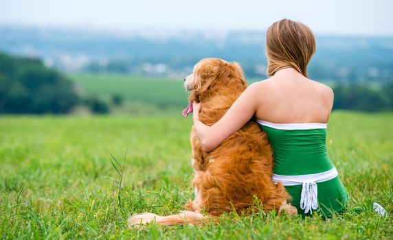 Girl with retriever on the grass