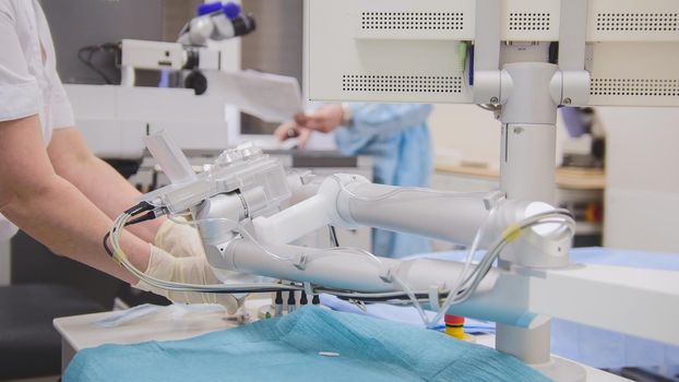 Surgeons and anesthesiologist prepare for surgery in an operating room - ophthalmology, close up