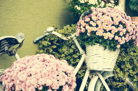 bike with flowers standing near the house