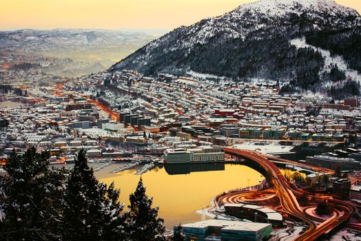 view from the mountains to Bergen in the winter with roads , Norway