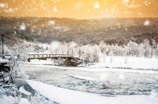 beautiful winter landscape with bridge in the mountains of Norway