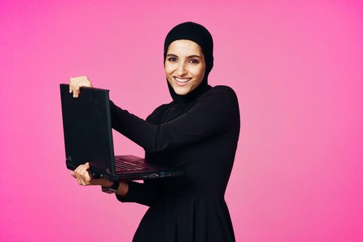 cheerful muslim woman with laptop education student internet technology. High quality photo