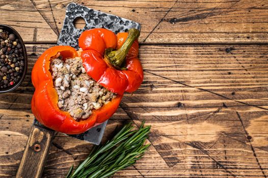 Roasted sweet bell pepper with meat, rice and vegetables. wooden background. Top view. Copy space.