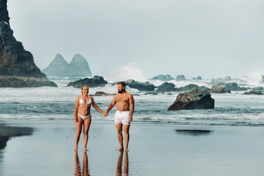 Benijo, Tenerife, Spain : Natural sand beach. Popular place for local people and tourists. Volcanic rocks billowi out of turquoise water and soft gentle waves washing the sandy shore