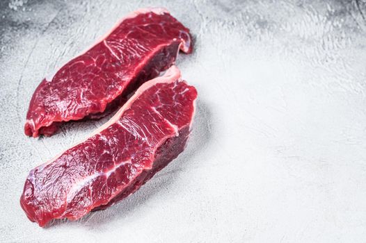 Fresh Raw sirloin beef meat steak. white background. Top view. Copy space.