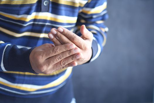 man suffering pain in hand close up .