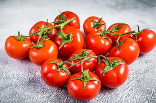 Fresh red tomatoes on kitchen table. White background. Top view.