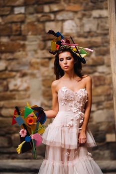 beautiful stylish girl model in a pink wedding dress photographed in Florence, holding an unusual bouquet, bride model with a bouquet in her hands, photo session of the bride in Florence