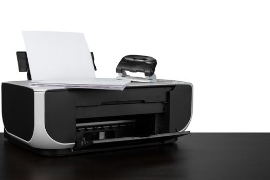 Laser home printer on table against white background, close up
