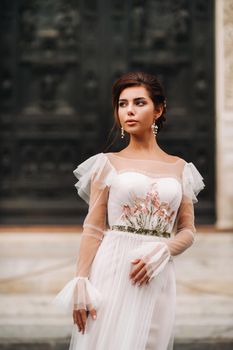 girl-bride wedding dress with a beautiful floral pattern in Florence, stylish bride in a wedding dress stands in the Old city of Italy. Model girl in Florence.