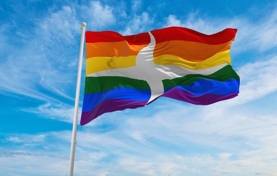 flag of Interlingua Pride waving in the wind at cloudy sky. Freedom and love concept. Pride month. activism, community and freedom Concept. Copy space. 3d illustration