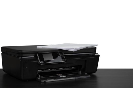Laser home printer on table against white background, close up