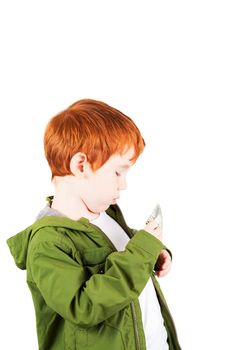 red-haired boy in a green jacket with dollars that he puts in his jacket pocket