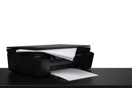 Laser home printer on table against white background, close up