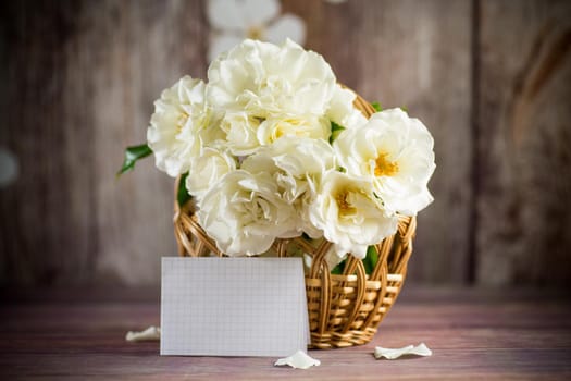 bouquet of beautiful white roses on a wooden table