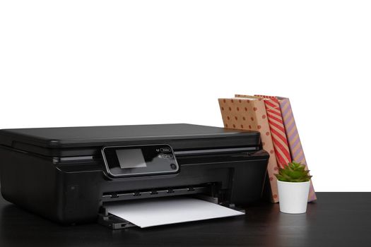 Working table with printer and stacked books on white abckground, close up