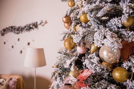 Christmas toys on a fir-tree close up with interior background