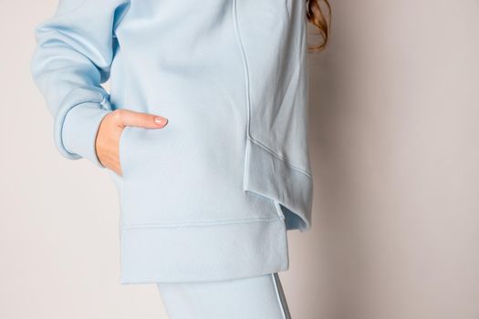 Elegant stylish girl in in white hoodie and black trousers sitting and relaxing in summer