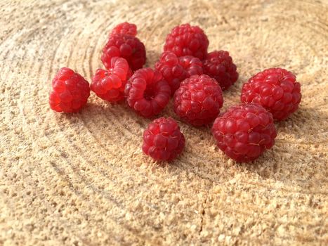 Ripe fresh raspberries on a wooden background, macro close up