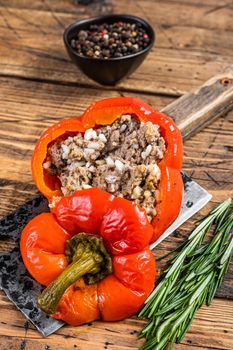 Roasted sweet bell pepper with meat, rice and vegetables. wooden background. Top view.