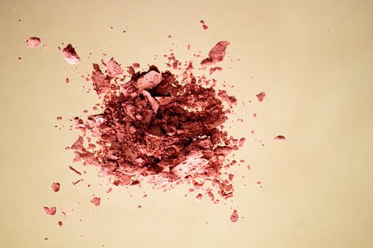 Crushed cosmetics, mineral organic eyeshadow, blush and cosmetic powder isolated on golden background, makeup and beauty banner, flatlay design.