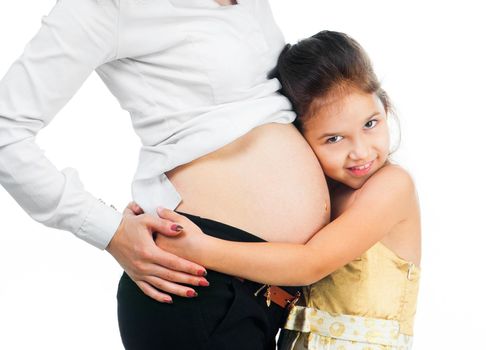 cute little girl hugging belly pregnant mom