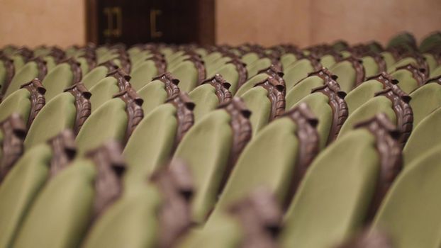 Concert Hall - spectators come into green chairs - de-focused time-lapse, close up