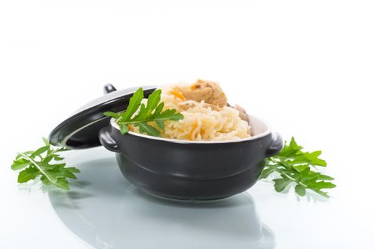 light boiled rice with vegetables and meat in a ceramic bowl isolated on white background