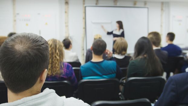 A lot of people sitting at a seminar lectures and conferences - businessmen and IT professionals, close up