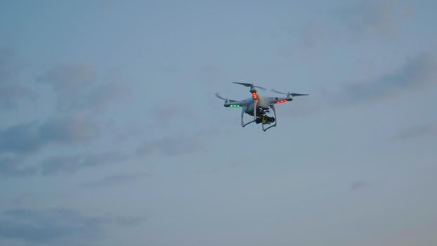 Video Drone flying in the evening summer sky with clouds, telephoto