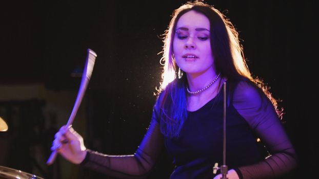 Teen rock music - Passionate dashing girl percussion drummer perform music break down, close up