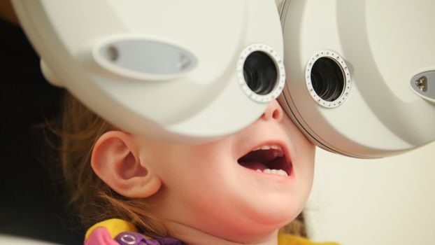 Healthcare - little beautiful girl in ophthalmologist room, close up