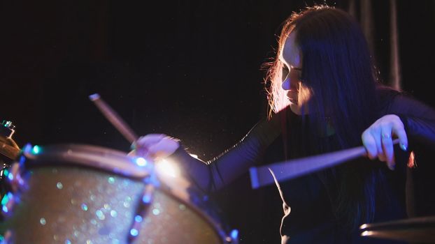 Passionate girl with long hair - percussion drummer perform music break down - teen rock music, telephoto