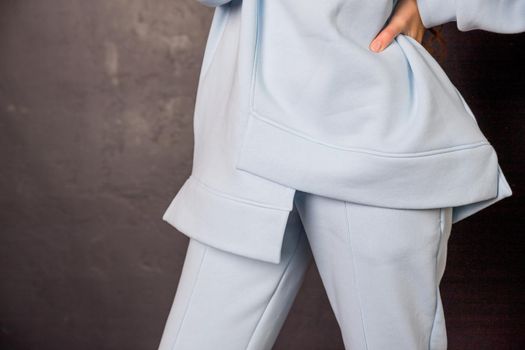 Elegant stylish girl in in white hoodie and black trousers sitting and relaxing in summer