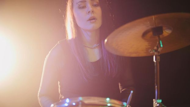 Teen rock music - attractive girl percussion drummer perform music break down, telephoto