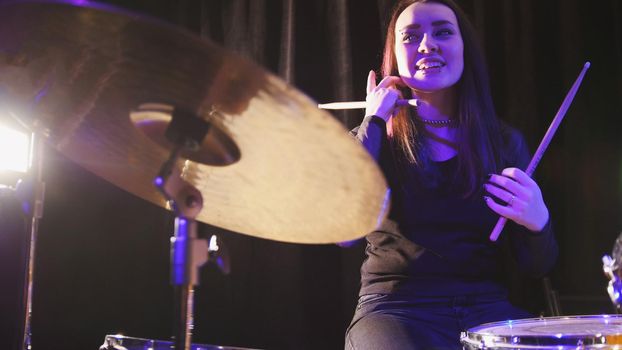 Girl percussion drummer performing with drums, telephoto