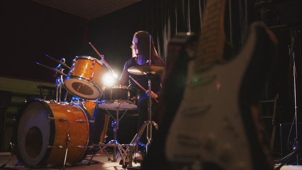 Girl drummer, attractive young woman plays the drums, horizontal