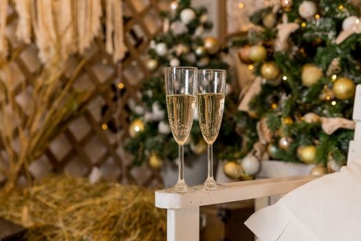 Two glasses of champagne with lights in the background. very shallow depth of field, focus on near glass.